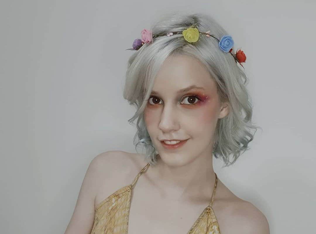 girl with white curls with flowers