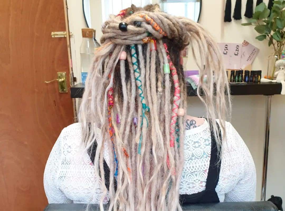 girl with white dyed dreads with beads and ribbons